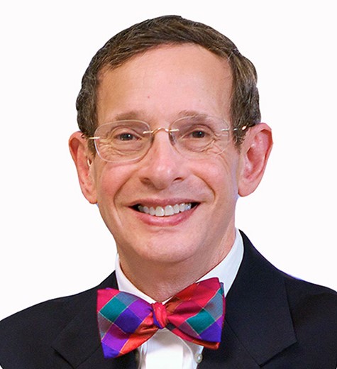 Gerald P. Koocher, Ph.D., LP, ABPP, wearing glasses and a suit in a professional headshot.