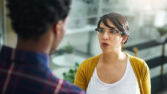 A woman having a serious conversation with someone, demonstrating interpersonal communication.