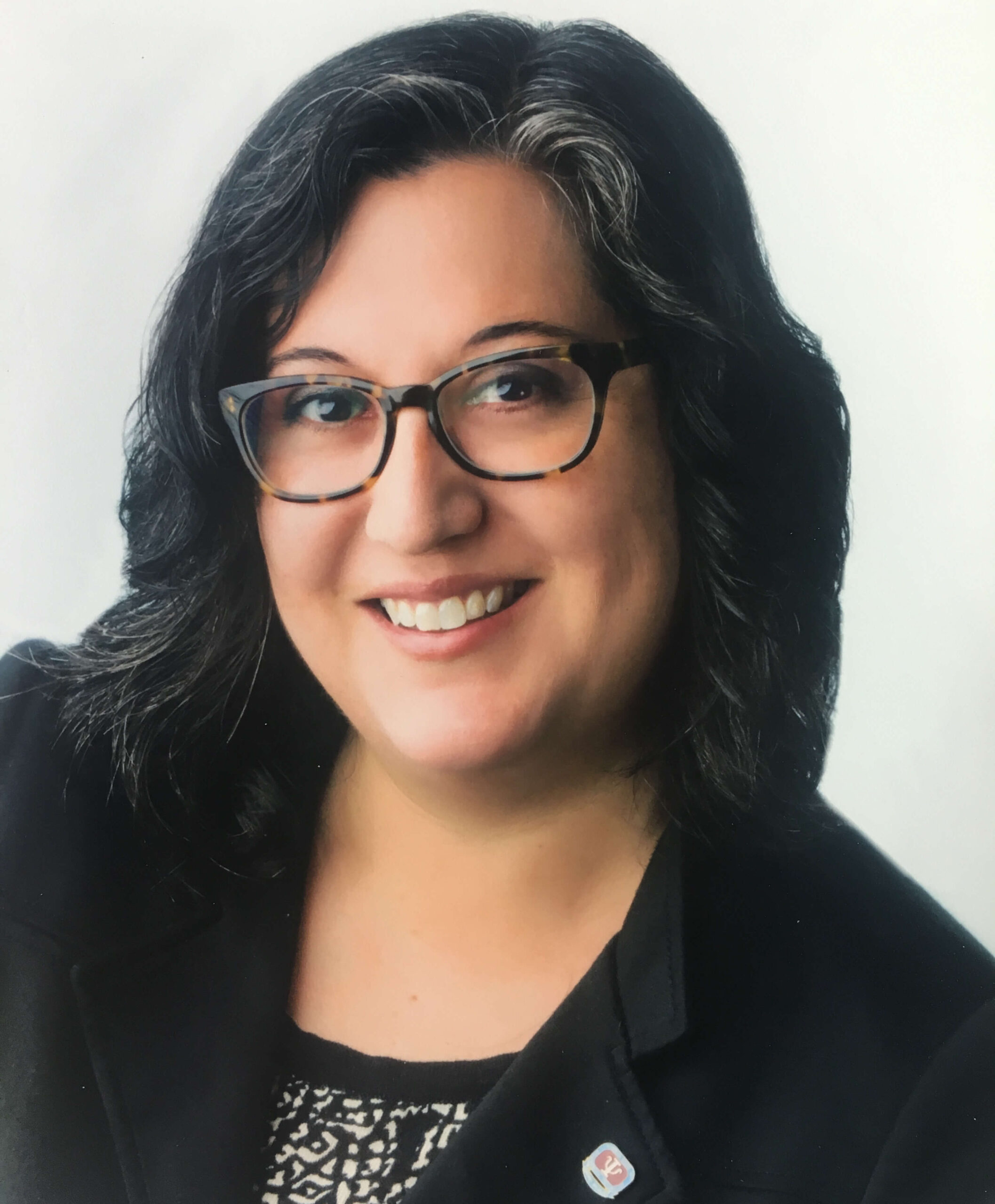 Lynette M. Abrams-Silva, Ph.D., ABPP, wearing eyeglasses, smiling in a professional portrait.